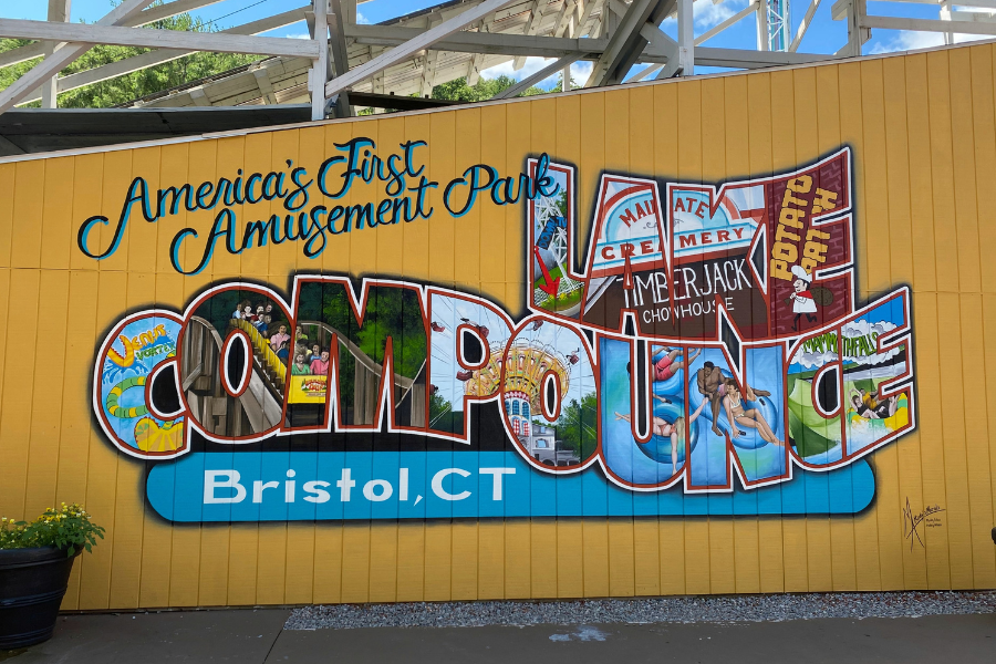 painted lake compounce sign on a yellow background with images around the park inside of the letters