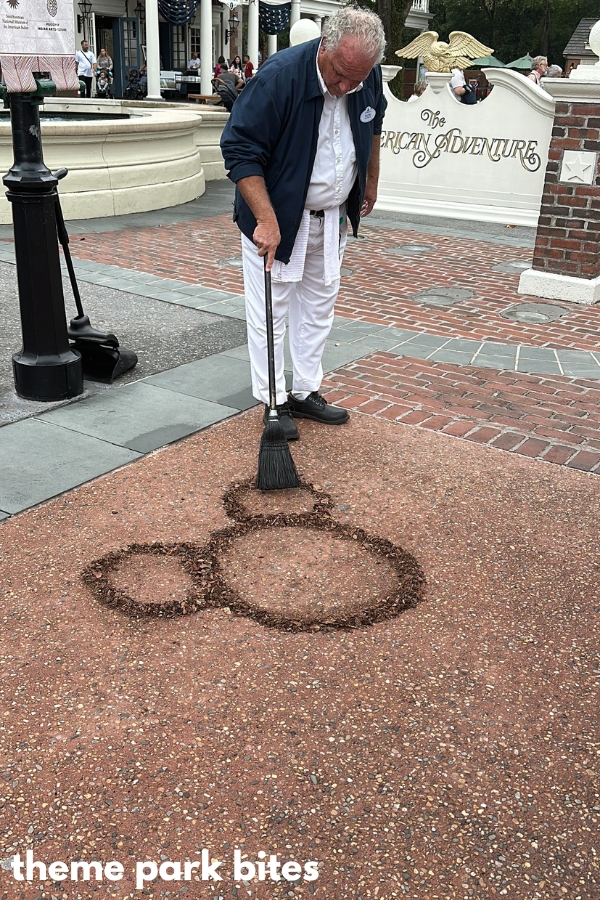 disney employee creating a mickey head from leaves in the american adventure section of epcot